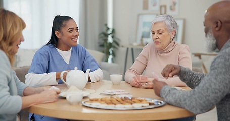 Image showing Tea, happy and retirement with friends and playing cards in living room for relax, diversity and poker. Games, smile and community with group of old people in nursing home for party and celebration