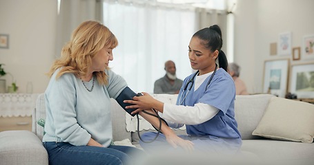 Image showing Nurse, appointment and blood pressure with senior woman at nursing home for wellness. Caregiver, service and elderly female for consultation in living room for diabetes with communication for health.