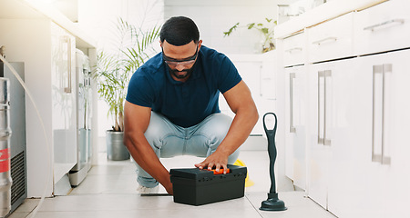 Image showing Plumber man, tools and box on floor maintenance with packing, focus and pipe repair service in house. Entrepreneur handyman, plumbing expert and small business owner with toolbox in home kitchen