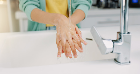 Image showing Washing hands, woman cleanse and kitchen sink of a female with soap for cleaning and wellness. Home, safety and virus protection of a person with healthcare in a house for skincare and grooming