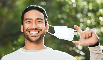 Image showing Man, face mask and forest with smile, portrait and freedom for wellness, health and breathing in sunshine. Asian guy, covid ppe and excited for medical protection, immune system and outdoor in woods