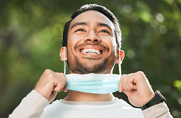 Image showing Corona, Asian man and take off mask for end of pandemic, vaccine safety and outdoor protected. Covid policy, happy guy and Japanese person remove face cover for breathing and decrease infection rates