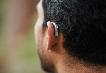 Image showing Closeup of hearing aid, ear and man with disability from the back for medical support, listening and healthcare tech. Deaf patient, face and audiology implant to help volume, vibration or sound waves