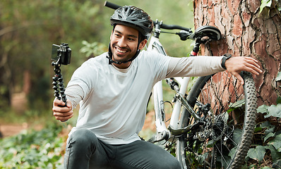 Image showing Man, selfie and bike by trees, forest and smile for training, health and outdoor adventure with web blog. Influencer guy, cycling and bicycle with live stream, profile picture and social media post