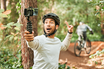 Image showing Cycling man, selfie and happy in forest, pointing and excited for wellness, training or blog on adventure. Influencer guy, helmet and smile in profile picture, memory or live stream on social network