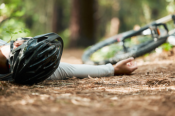 Image showing Sports, fitness and cycling accident with a man on the ground while training for a race in the forest. Exercise, crash and fall with a cyclist unconscious in the woods during a nature workout closeup