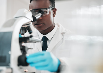 Image showing Microscope, black man and chemistry with research, medical and experiment with biotechnology. African person, science and researcher with laboratory equipment, healthcare and check vaccine results