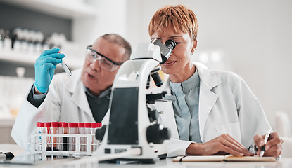 Image showing Science, team and microscope for test in laboratory, medical investigation or healthcare innovation. Man, woman and biotechnology analysis for vaccine development, chemistry research and review notes