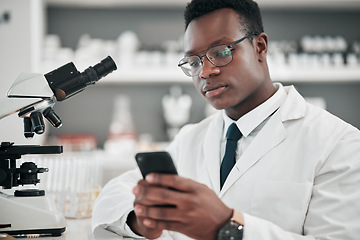 Image showing Medical science, man and a phone in a laboratory for online communication, email or website. African scientist person with smartphone typing for medicine research, social media or network database