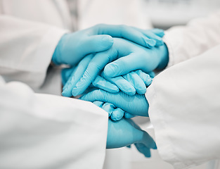 Image showing Ppe, doctor and nurse hands together for teamwork, solidarity and collaboration in hospital with gloves. Medical workers, professional people and support for healthcare, motivation and community