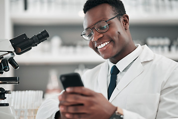 Image showing Man, medical science and a phone in a laboratory for online communication, email or website. Happy African scientist person with smartphone typing medicine research, social media or network database