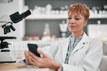 Image showing Medical science, woman and a phone in a laboratory for online communication, email or website. Mature scientist person with smartphone typing medicine research, results or network database app