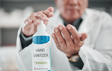 Image showing Doctor, sanitizer bottle and cleaning hands for risk, hygiene and protocol in hospital, clinic and surgery. Closeup, healthcare worker and disinfection liquid for safety, flu germs and virus bacteria