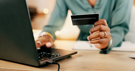 Image showing Laptop, credit card and woman hands for business online shopping, transaction or fintech payment in night office. Professional black person typing her banking information on computer or financial app