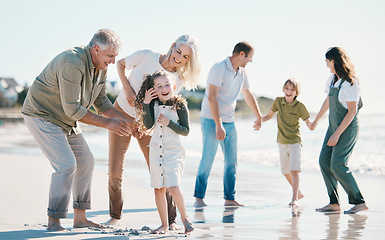 Image showing Grandparents, kids and big family with play at beach, comic laugh or bonding for love, sunshine or excited on vacation. Men, women and children by sea, waves or happy for holiday for summer in Spain