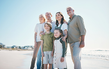 Image showing Grandparents, kids and big family with smile at beach, hug or bonding for love, sunshine or excited on vacation. Men, women and children by sea, waves or happy embrace for holiday for summer in Spain