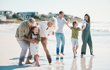 Image showing Grandparents, children and big family with play at beach, comic laugh or bonding for love, sunshine or excited on vacation. Mom, dad and kids by sea, waves and freedom on holiday for summer in Spain