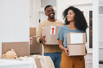 Image showing Happy black couple, box and moving in new home, property or investment together in happiness. African man and woman smile with boxes in renovation, relocation or house mortgage and apartment loan