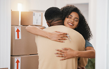 Image showing Happy couple, hug and real estate in new home, moving in or boxes for investment or ownership together. Man and woman with keys in embrace for property, relocation or renovation in house mortgage