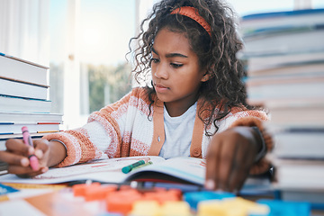 Image showing Art, homework and child coloring in a book for artistic project, assignment or fun. Crayon, education and girl kid student writing for creative learning in a notebook by a desk at modern home.