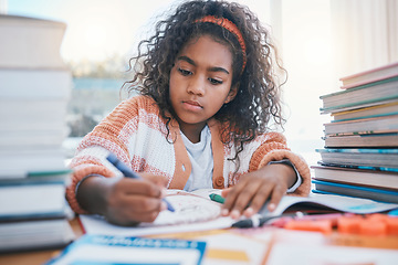 Image showing Education, art and kid coloring in a book for artistic project, assignment or fun. Colors, crayon and girl child student writing for creative learning in a notebook for homework by a desk at home.