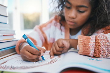 Image showing Education, homework and child coloring in a book for artistic project, assignment or fun. Colors, hobby and girl kid student writing for creative learning in a notebook by a desk at modern home.