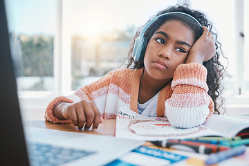 Image showing Child, headphones and girl tired of home school, e learning and future online education. Thinking, bored and kid with ADHD, autism and sad at laptop while drawing and listening to audio at table