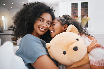 Image showing Family, hug and living room with kid, mother and love together in a home on a couch. Smile, relax and young girl with mother and calm with bonding, teddy bear and care in a house on a lounge sofa