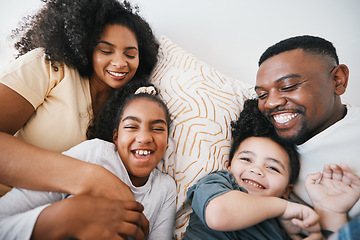 Image showing Mom, dad and kids in bed with tickling, comic joke and laugh with bonding, care and love in family home. Black man, mother and daughter with smile, playful game and crazy in bedroom, morning or house