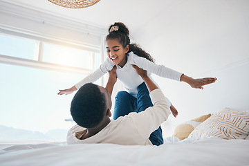 Image showing Happy, airplane and father with girl child on a bed for bond, trust or support in their home together. Flying, family time and parent with kid in a bedroom for games, love or fun with weekend freedom