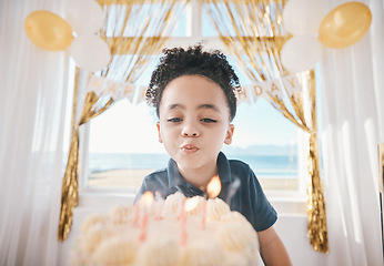 Image showing Birthday, cake and party with child and candles for gift celebration, food and dessert. Excited, balloons and happy with young boy making wish in family home for surprise, flame and holiday event