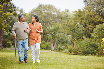 Image showing Park, love and mature couple walking, support or outdoor conversation, garden communication or nature mockup space. Trees, wellness care and relax man, woman or marriage people trust, talking or bond