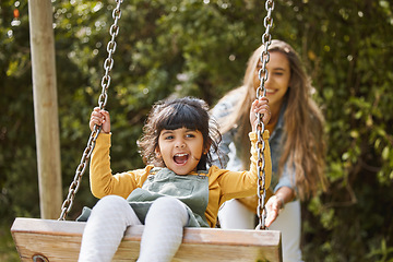 Image showing Happy, swing and mother and child in park for playing, bonding and having fun together outdoors. Nature, weekend and mom push little girl in playground for relaxing, childhood and happiness in summer