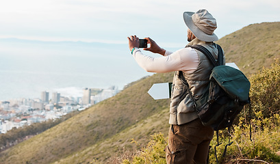 Image showing Phone, hiking and photography of black man in nature, adventure and travel on holiday vacation. Mobile, picture of city and person trekking outdoor, tourist journey and view of countryside landscape