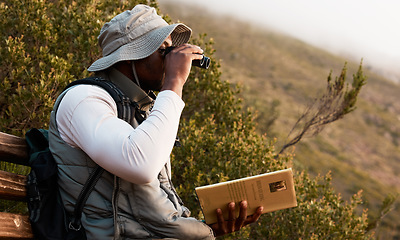 Image showing Book, binocular or man bird watching in nature on trekking adventure journey for wellness or peace. Hiking, holiday vacation or African person on bench to relax or looking to search in park for view