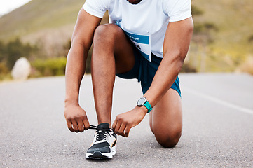 Image showing Road, fitness and hands of man with shoes tie for running, training or race preparation outdoor zoom. Legs, runner and sneakers check by male athlete in street for exercise, competition or workout