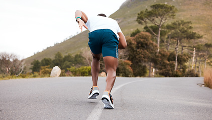 Image showing Fitness, race or runner running on road by nature for exercise, training or outdoor workout. Back view, fast black man or active athlete on street with endurance, freedom or sports challenge on hill