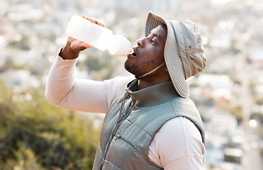 Image showing Hiking, drinking water and black man with fitness, health or hydration with workout, peace or exercise. African person, travel or hiker with bottle for liquid, thirsty or nature with wellness or aqua