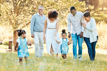 Image showing Nature, happy and family generations in a park for bonding, having fun and talking together. Love, smile and children walking with parents and grandparents in an outdoor green garden on weekend trip.