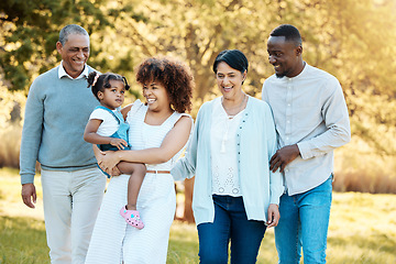 Image showing Nature, walking and family generations in a park for bonding, having fun and talking together. Happy, smile and child with her parents and grandparents in an outdoor green garden on a weekend trip.