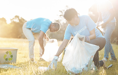 Image showing Nature recycling, community service volunteer and woman cleaning garbage, grass field trash or plastic pollution. Earth Day cooperation, eco project and charity team help with product clean up