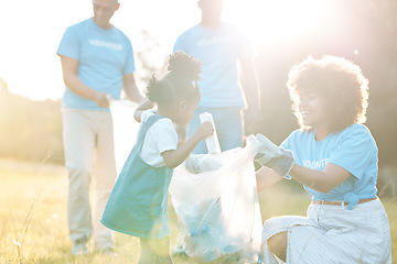 Image showing Nature activist, volunteering family and child cleaning garbage pollution, trash litter and throw bottle in plastic bag. Group teamwork, waste management and mother helping kid with clean up project
