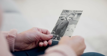 Image showing Senior woman, holding and photo with memory with hands and remembering a child in closeup. Retirement, history and elderly person with retro picture in home with nostalgia or thinking about past.