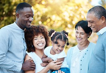 Image showing Happy, love and family generations in nature at an outdoor park together for bonding. Smile, fun and girl child with grandparents and parents in a green garden on weekend trip, adventure or holiday.