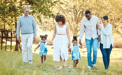 Image showing Nature, walking and children with parents and grandparents in a park for bonding, having fun and talking together. Happy, smile and family generations in an outdoor green garden on a weekend trip.