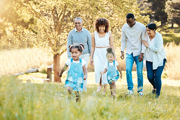 Image showing Park, walking and happy family generations for bonding, having fun and talking together. Love, smile and children with parents and grandparents in nature in an outdoor green garden on weekend trip.