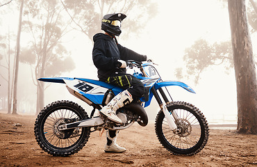 Image showing Motorcycle, person and sports in woods with training for competition, ride in nature with action and helmet. Extreme, adrenaline and exercise, athlete and transport with dirt bike, freedom and travel