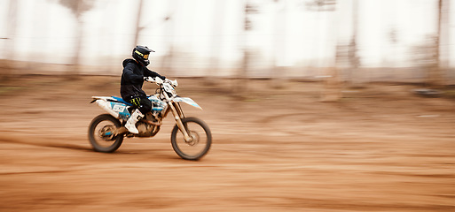 Image showing Motorcycle, speed and motion blur with a sports man on space in the forest for dirt biking. Bike, fitness and power with a person driving fast on an off road course for freedom or performance