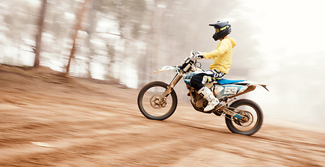 Image showing Motorcycle, speed and uphill with a sports man on space in the forest for dirt biking. Bike, fitness and power with a person driving fast on an incline or off road course for freedom or performance