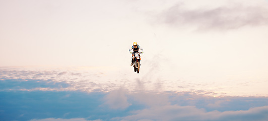 Image showing Motorcycle, blue sky and jump for training or sports with fitness, balance or challenge in nature on mock up space. Bike, freedom and adventure for competition, exercise or talent with safety gear